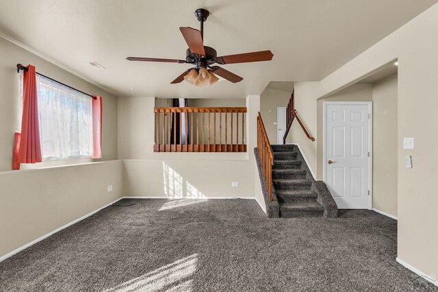 806 N Monarch Dr, Pueblo, CO 81007 - unfurnished living room with carpet, ceiling fan, stairs, and baseboards