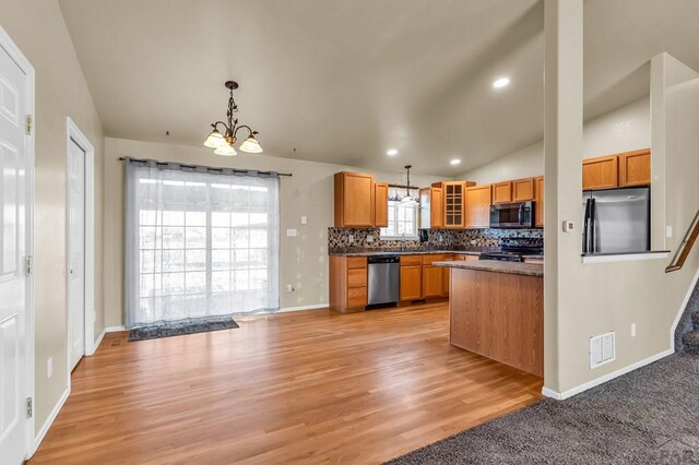 806 N Monarch Dr, Pueblo, CO 81007 - kitchen featuring stainless steel appliances, lofted ceiling, decorative backsplash, glass insert cabinets, and a chandelier