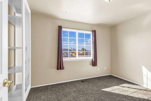 806 N Monarch Dr, Pueblo, CO 81007 - carpeted empty room featuring baseboards