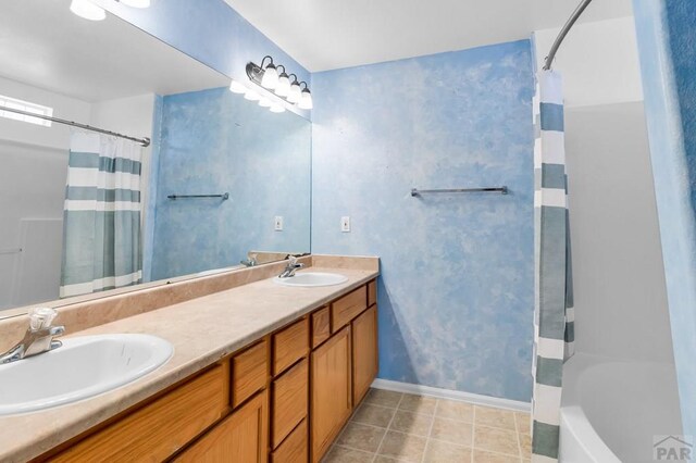 806 N Monarch Dr, Pueblo, CO 81007 - bathroom featuring baseboards, double vanity, tile patterned flooring, and shower / tub combo