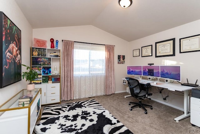 carpeted home office featuring lofted ceiling and baseboards