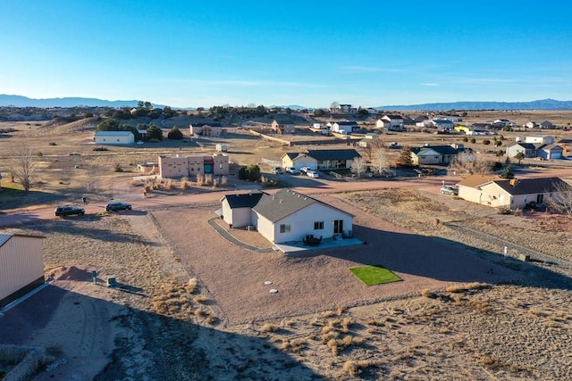 drone / aerial view featuring a residential view and a mountain view