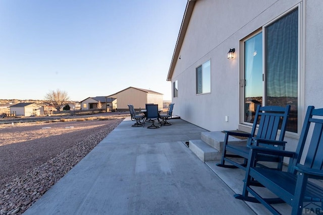 view of patio with a residential view and outdoor dining area