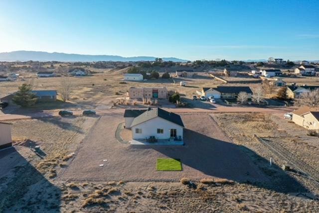 birds eye view of property with a mountain view