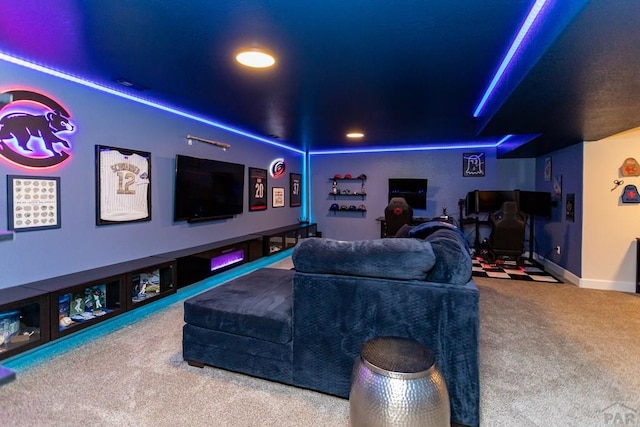 carpeted home theater with baseboards