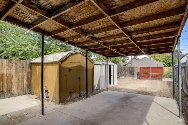 view of patio / terrace featuring a storage shed, a fenced backyard, and an outdoor structure