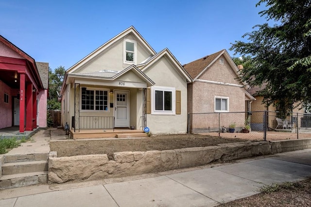 view of front of property featuring stucco siding and fence