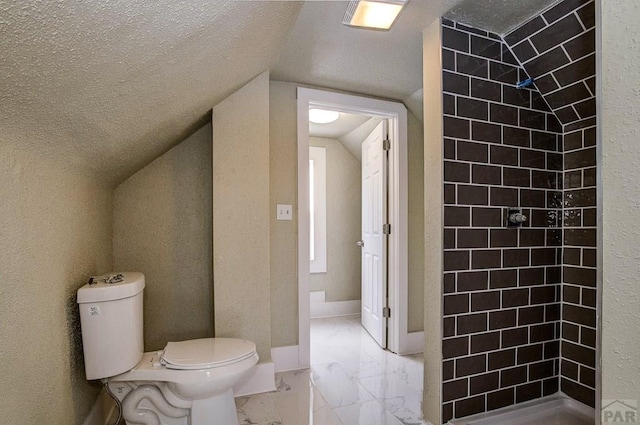 full bath with lofted ceiling, toilet, marble finish floor, and tiled shower