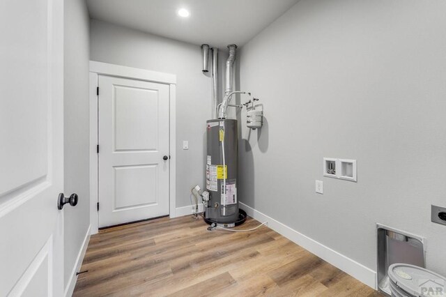 utility room featuring gas water heater