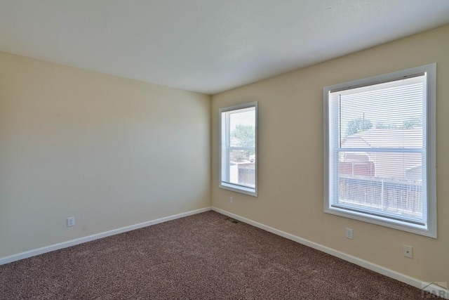 spare room with carpet flooring and baseboards