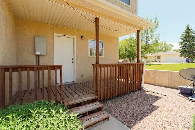 property entrance with a wooden deck and stucco siding