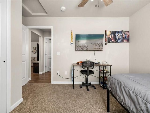 carpeted bedroom featuring baseboards and a ceiling fan