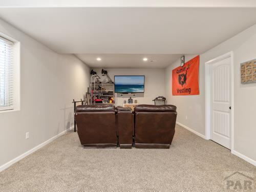 carpeted living room featuring recessed lighting and baseboards