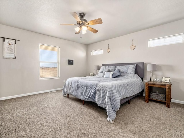 carpeted bedroom featuring baseboards and a ceiling fan