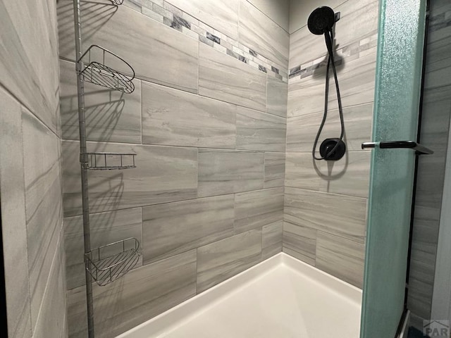 bathroom with tiled shower