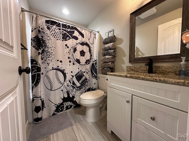 bathroom featuring toilet, a shower with curtain, and vanity