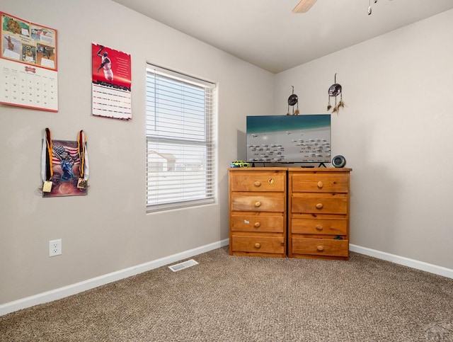 carpeted bedroom featuring baseboards, visible vents, and a ceiling fan