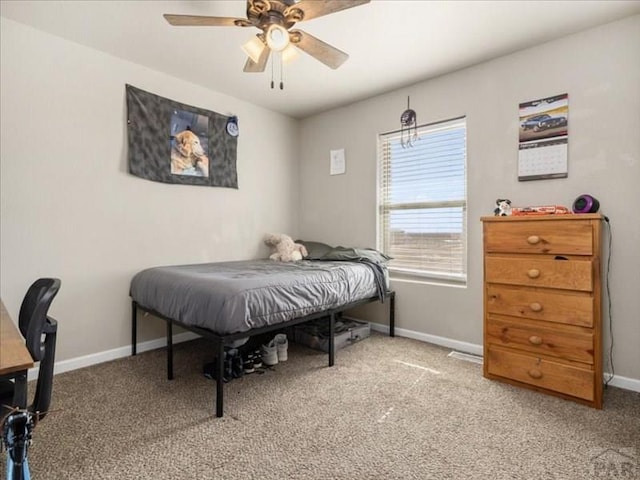 carpeted bedroom with a ceiling fan and baseboards