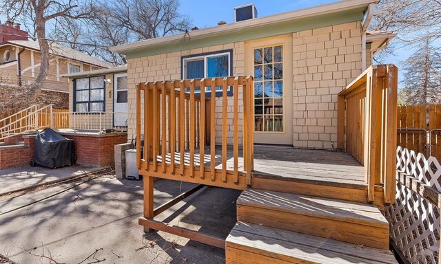 deck with area for grilling and fence