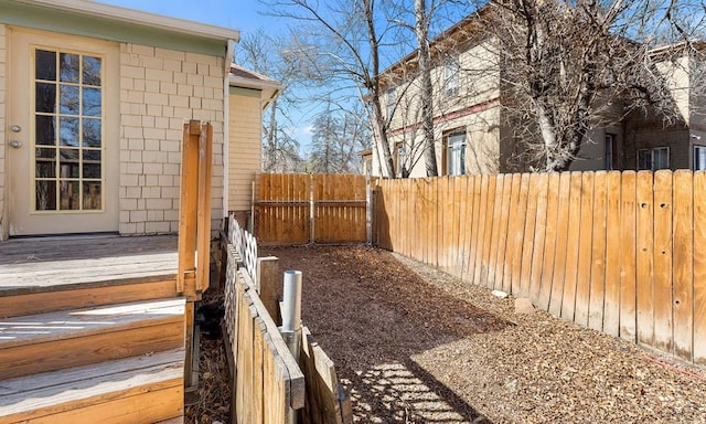 view of yard with a deck and a fenced backyard