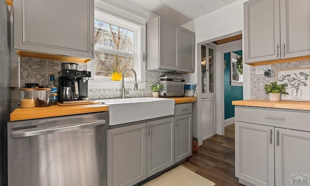 kitchen featuring wooden counters, gray cabinets, dishwasher, and a sink