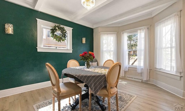 dining space with beam ceiling, baseboards, a chandelier, and light wood-type flooring