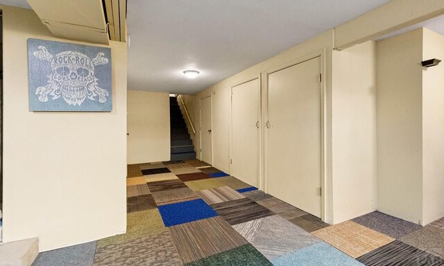 corridor featuring stairway and carpet floors