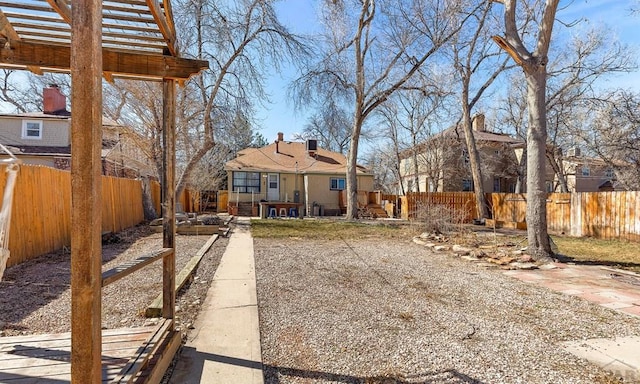 view of yard with a vegetable garden, a pergola, and a fenced backyard