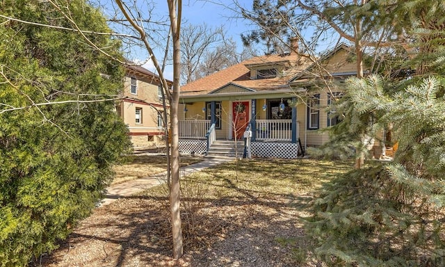 view of front of home with a porch and a chimney