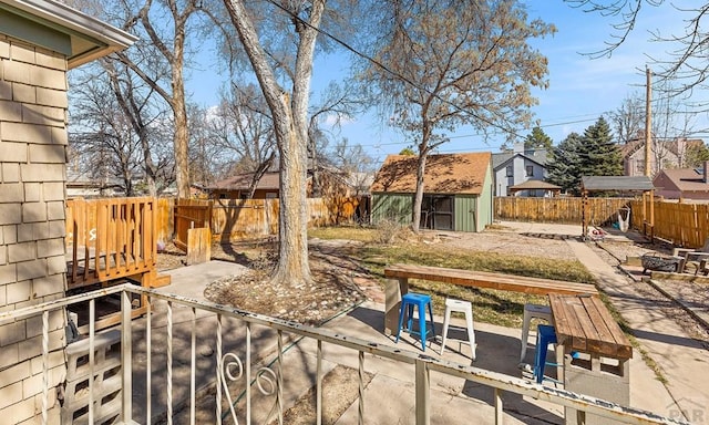 exterior space with a storage shed, a patio, a fenced backyard, and an outdoor structure