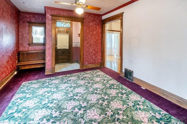 spare room with visible vents, baseboards, carpet, wallpapered walls, and crown molding
