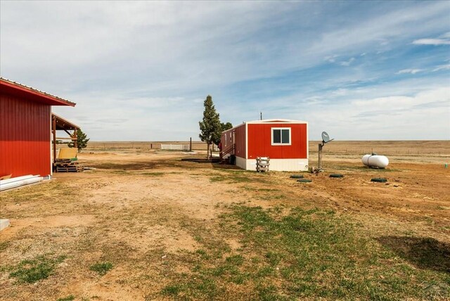 37155 E Jones Rd, Yoder, CO 80864 - view of yard featuring an outbuilding and a storage shed