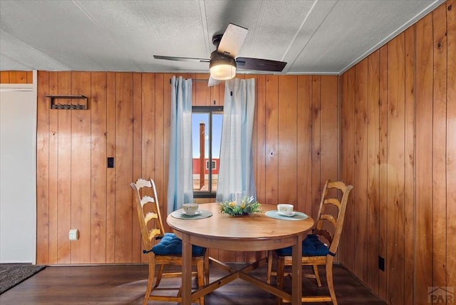 37155 E Jones Rd, Yoder, CO 80864 - dining area with ceiling fan, wood finished floors, and wooden walls