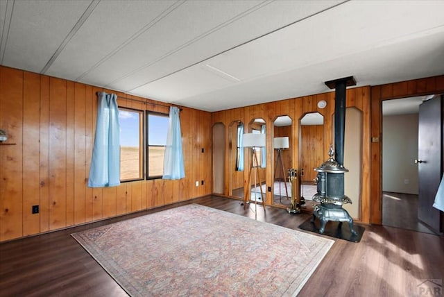 37155 E Jones Rd, Yoder, CO 80864 - living area featuring wooden walls, wood finished floors, and a wood stove