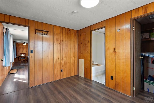 37155 E Jones Rd, Yoder, CO 80864 - empty room featuring wooden walls and dark wood-style floors