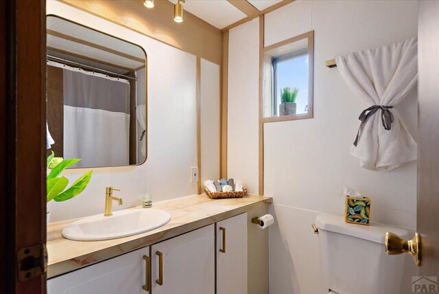 37155 E Jones Rd, Yoder, CO 80864 - full bath with curtained shower, toilet, and vanity