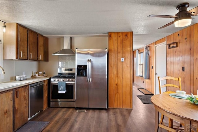 37155 E Jones Rd, Yoder, CO 80864 - kitchen with a sink, wall chimney range hood, light countertops, dark wood-type flooring, and appliances with stainless steel finishes