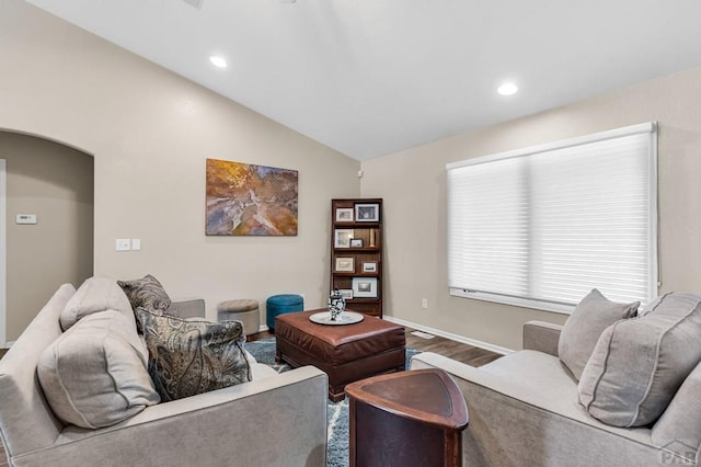 living area featuring baseboards, lofted ceiling, wood finished floors, and recessed lighting