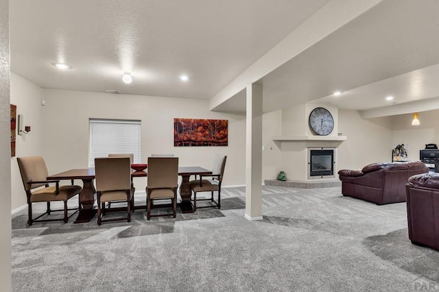 dining room with recessed lighting, carpet, a tile fireplace, and baseboards