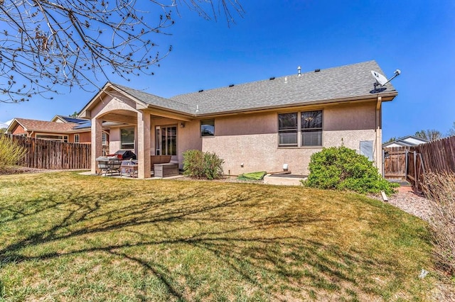 back of property featuring a fenced backyard, a yard, stucco siding, a patio area, and an outdoor living space