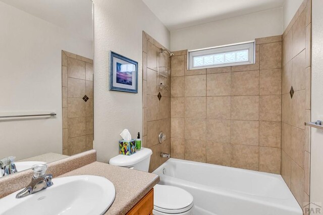 bathroom with vanity,  shower combination, and toilet