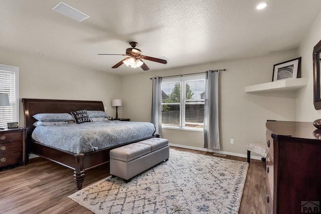 bedroom featuring baseboards, wood finished floors, recessed lighting, and ceiling fan