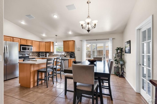 dining space with french doors, recessed lighting, a notable chandelier, lofted ceiling, and light tile patterned floors