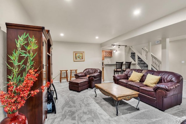 living area featuring baseboards, recessed lighting, visible vents, stairs, and carpet floors