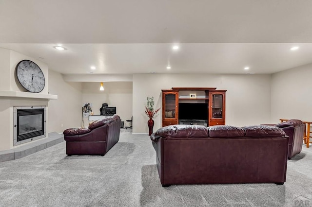 carpeted living area featuring a fireplace and recessed lighting