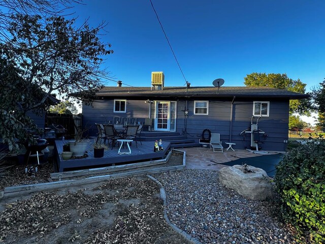 rear view of house with a wooden deck