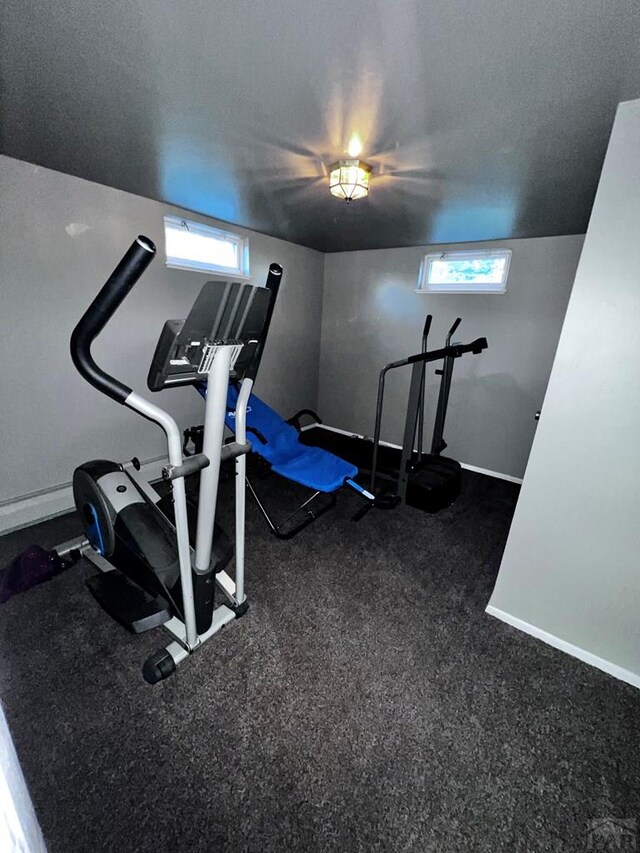 workout area featuring a textured ceiling, plenty of natural light, and baseboards