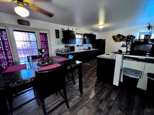 dining area featuring dark wood finished floors and a textured ceiling