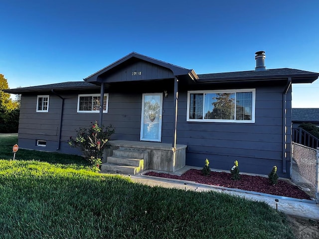 ranch-style home with a front lawn