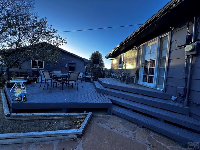 wooden deck featuring outdoor dining area and fence